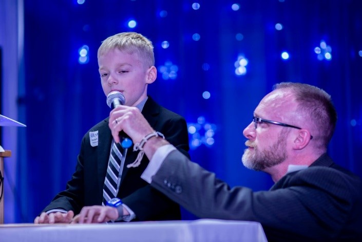 boy who is blind at microphone