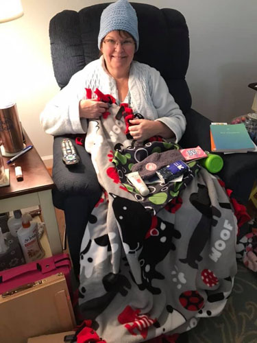 woman posing with care package items